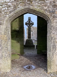 A celtic cross marks a grave inside the church